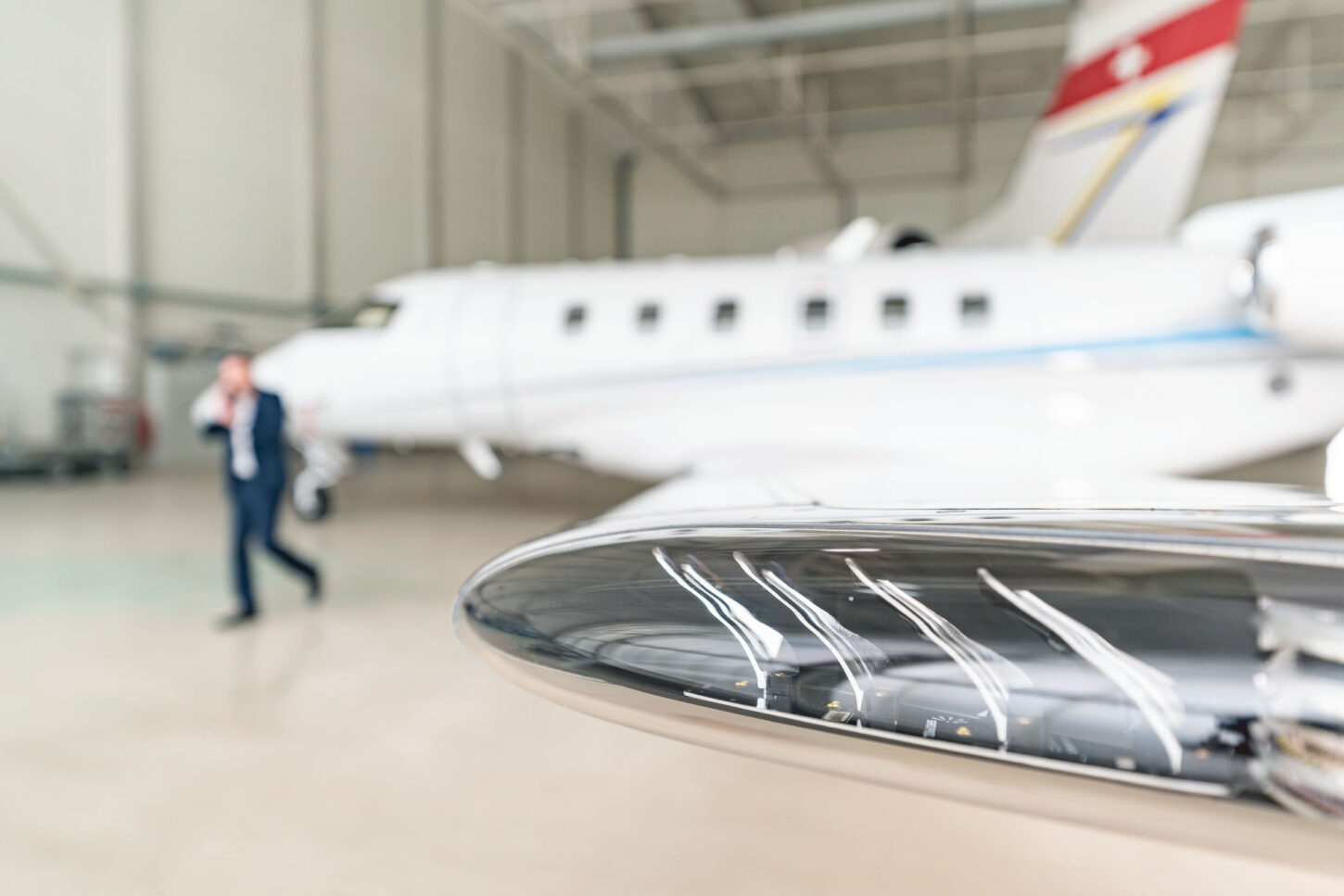 close up of the end of an arrow of a parked aircraft inside the hangar
