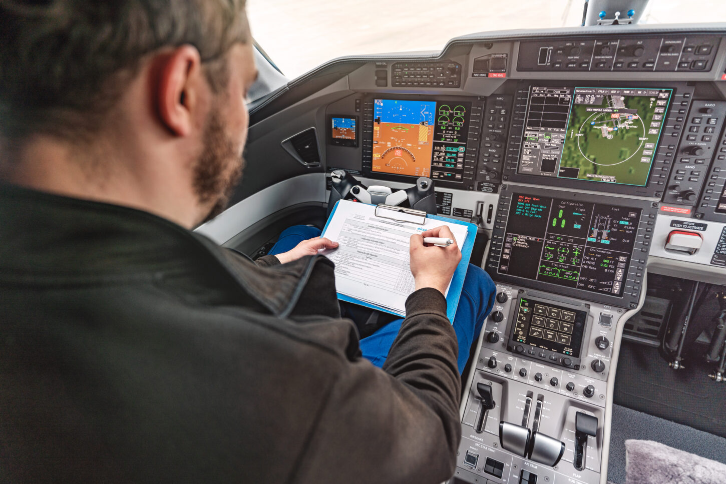 An aircraft maintenance specialist sits in the aircraft cockpit and checks all the devices on the pilot's cockpit.
